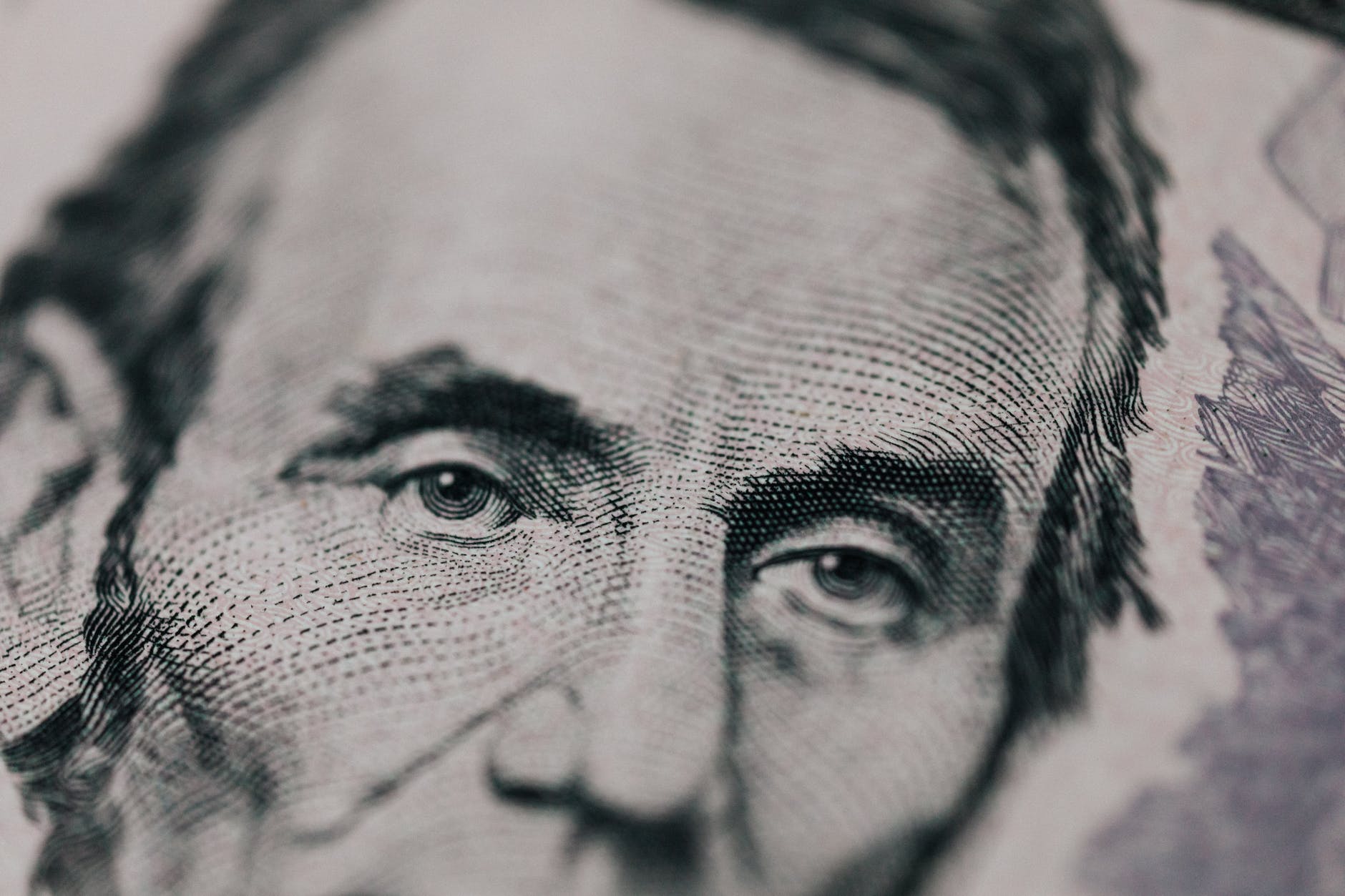 closeup of president printed on bill looking away